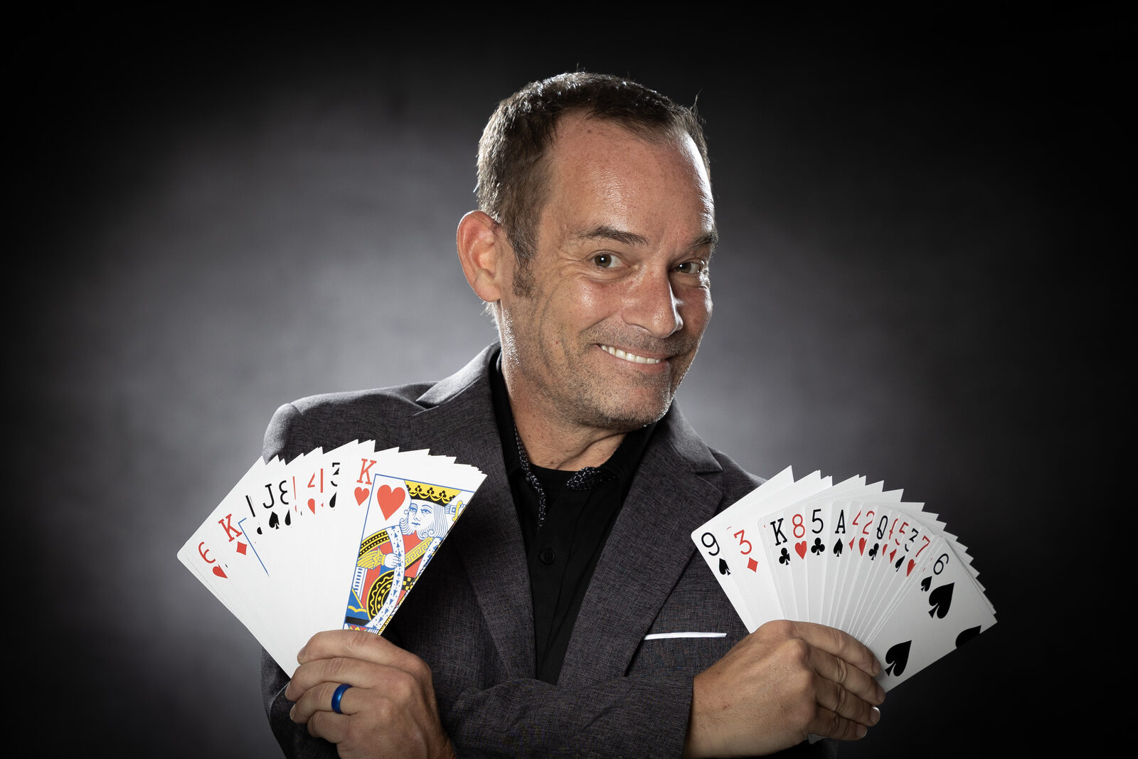 Chad Currin performing comedy magic on stage in front of a live audience