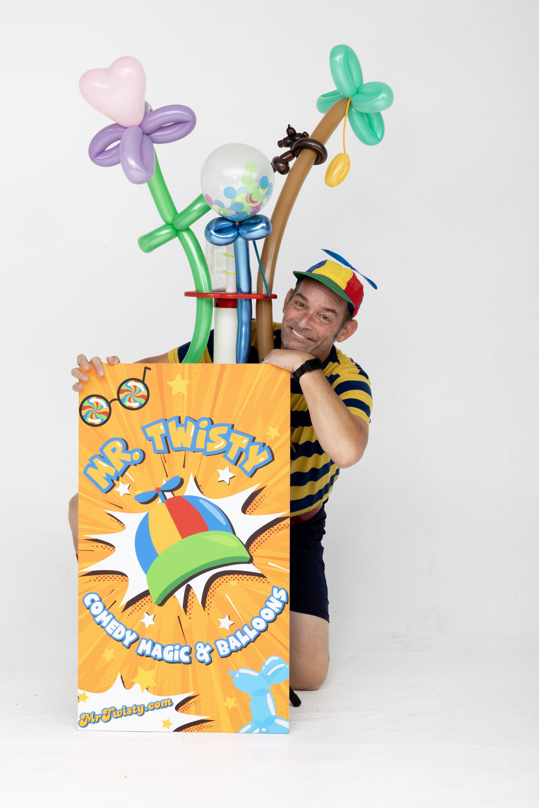 Mr. Twisty (Chad Currin) performing comedy magic and balloon twisting for a family audience